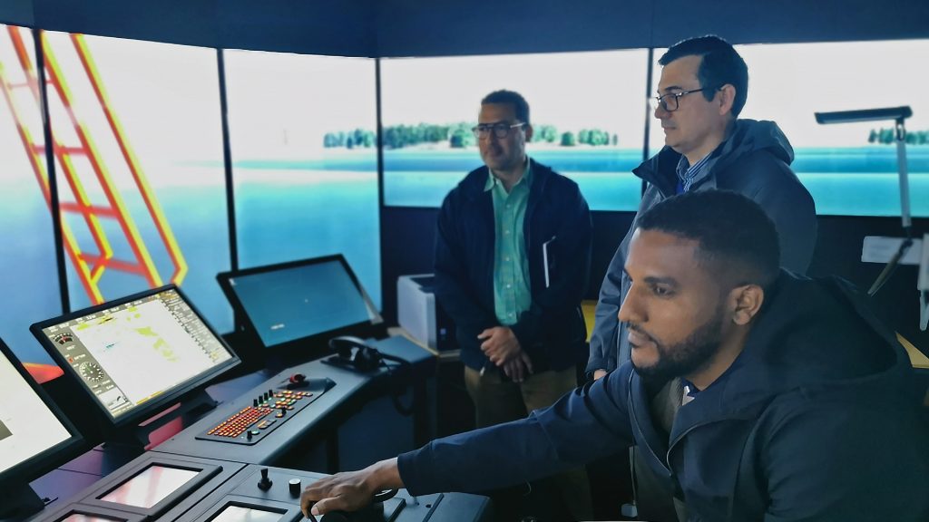 Three students from Cape Verde in the simulator room of the Rauma campus.