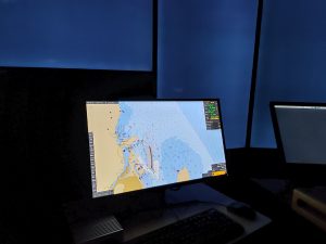 A map displayed on a computer screen. The room is dark.