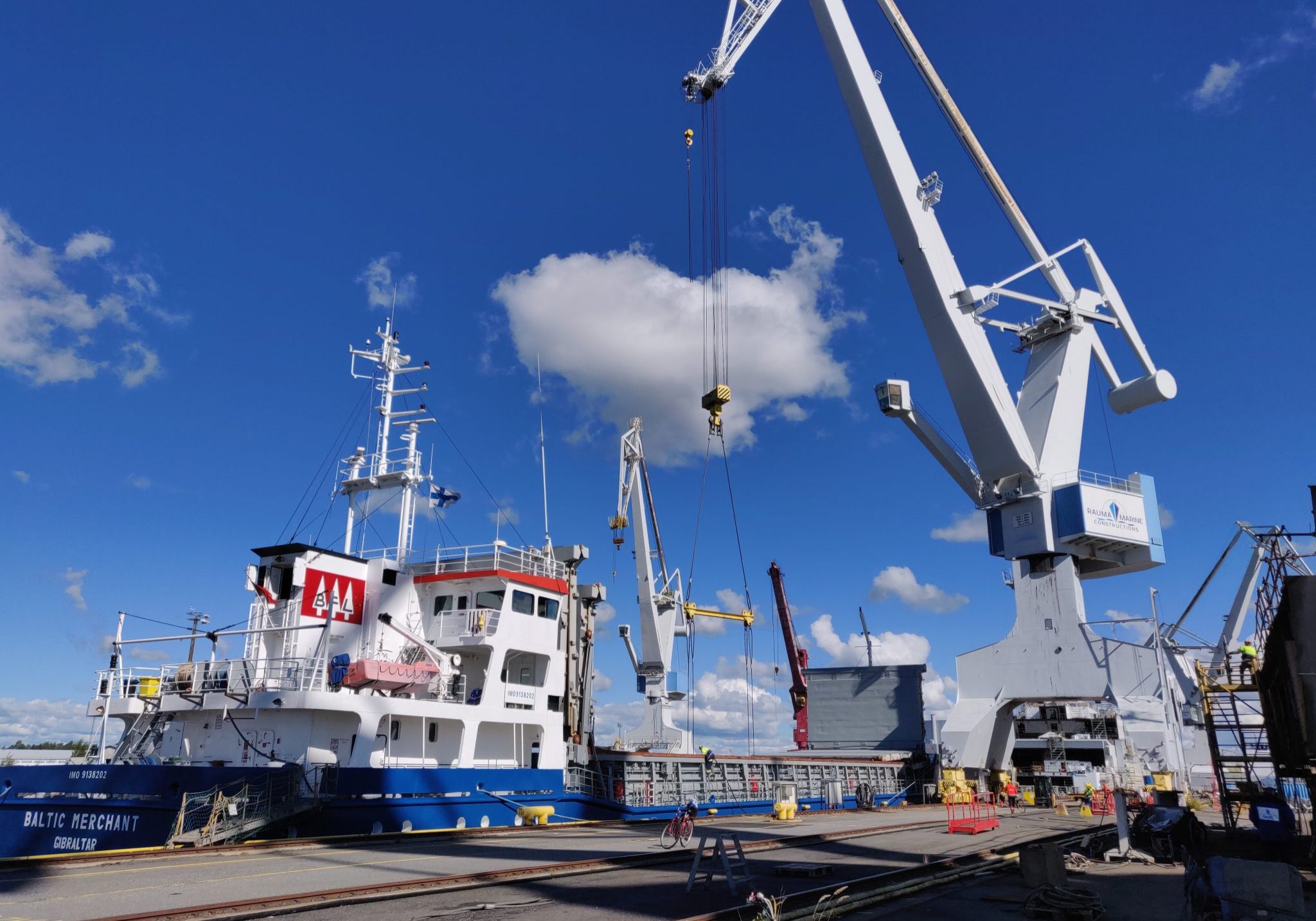 The crane unloads the ship in port.