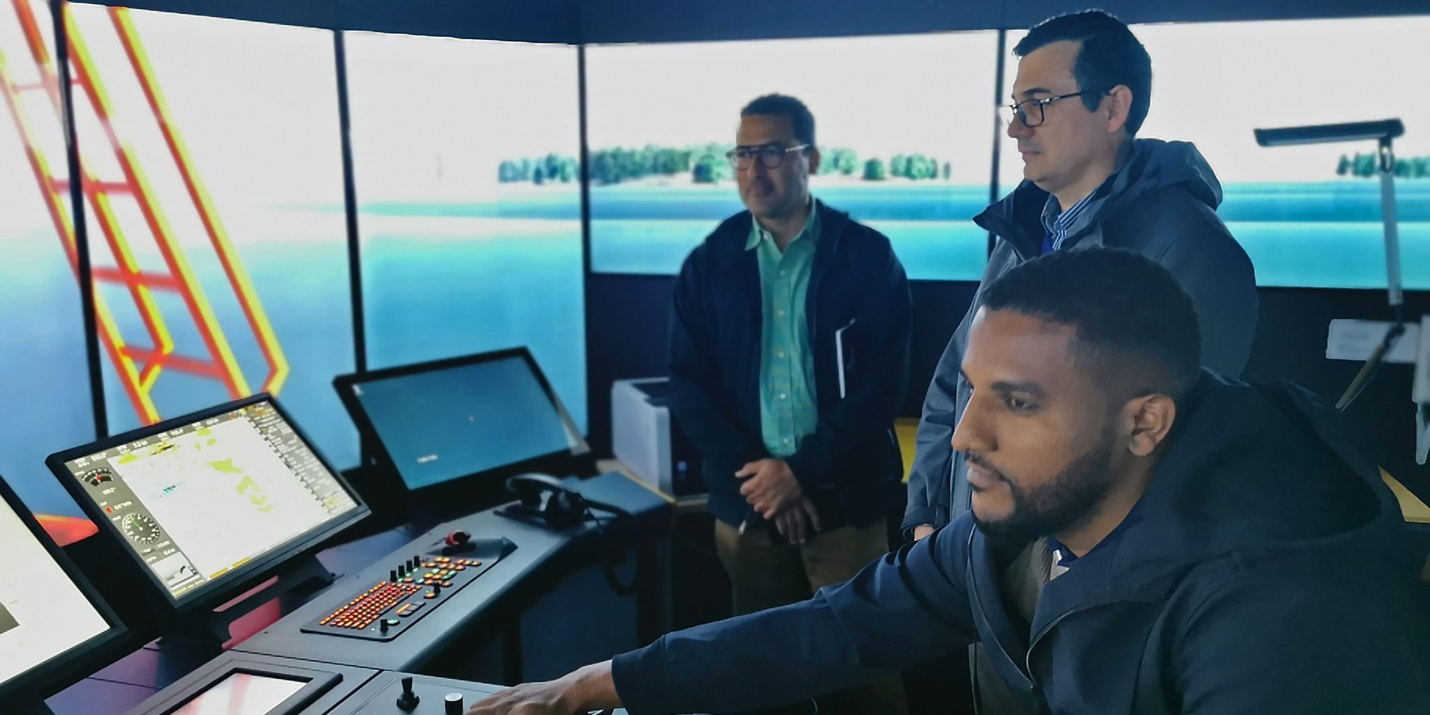 Three students from Cape Verde in the simulator room of the Rauma campus.
