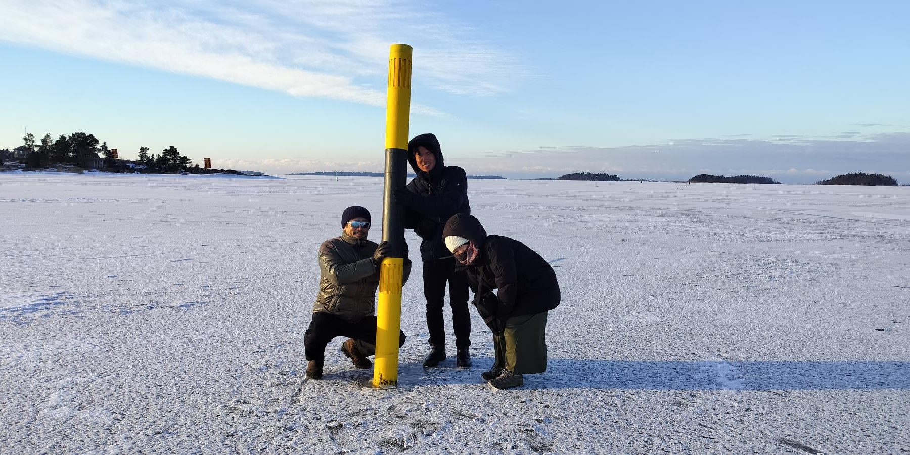 Koki Matsushima, Shohei Goto, Asami Shimada pose by a sea mark.